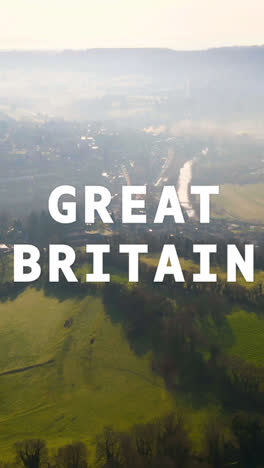 Vertical-Video-Aerial-Drone-Shot-Of-Fields-And-Countryside-In-UK-With-Animated-Graphic-Spelling-Out-Great-Britain